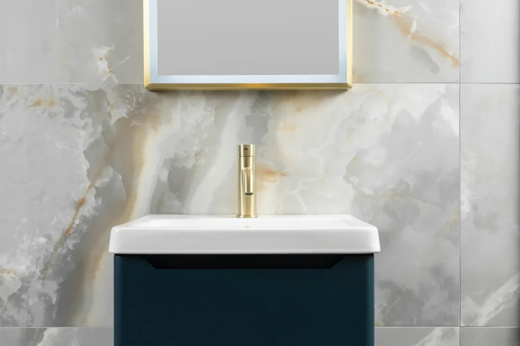 Marble-look porcelain wall with brushed brass tapware