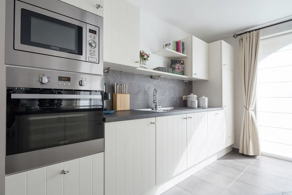 Grey tile splashback with integrated appliances